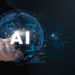 Un doigt touche une interface virtuelle marquée "AI" avec un globe terrestre en arrière-plan, symbolisant l’intelligence artificielle.